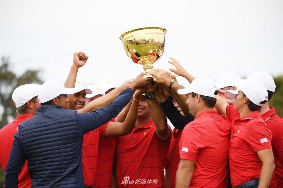 王者归来绝地反击 荣耀之战谱写传奇 美国队队员们围绕着奖杯欢呼雀跃,蓝色的队服与银色的奖杯在阳光下交织成一片欢乐的海洋。