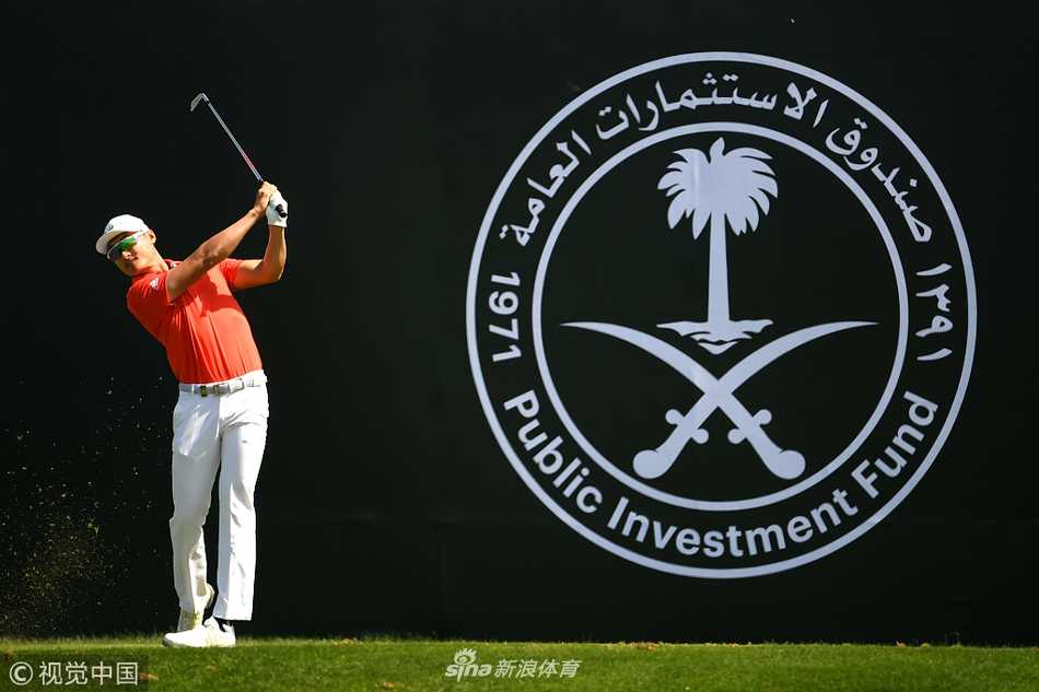 冠军达斯汀·约翰逊高举沙特国际赛奖杯，笑容灿烂，背景是夕阳下的皇家格林球场，定格了他新年首胜的荣耀时刻。