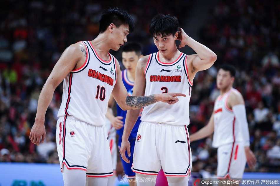 广东队主帅杜锋场边激情指挥，双手比划着战术手势，眼神中透露出对胜利的渴望和对场上局势的精准判断。