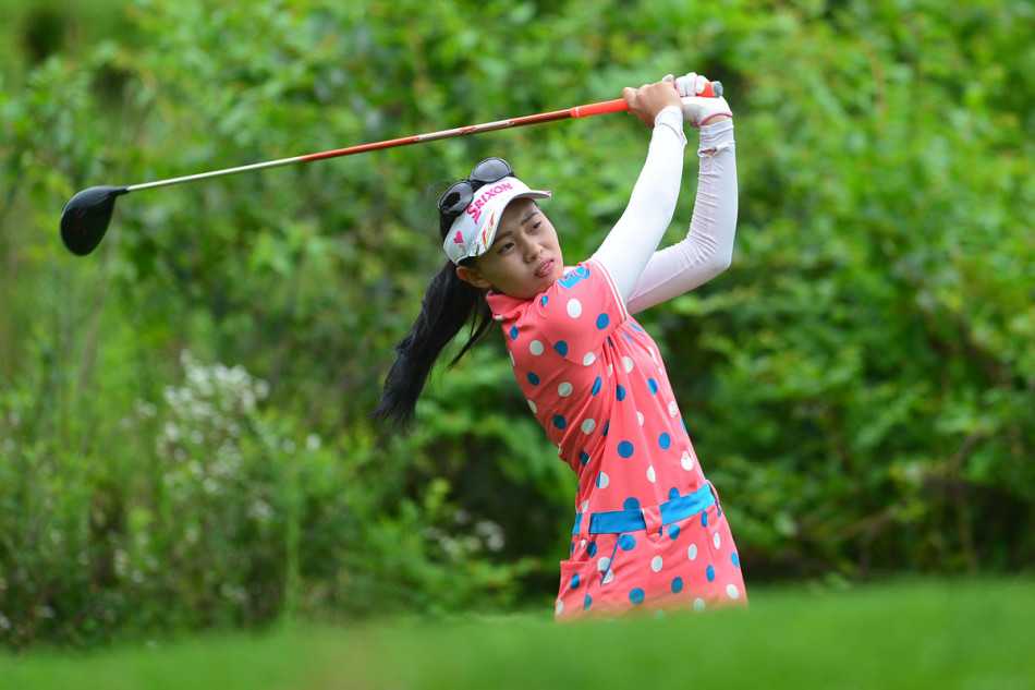 陈敏柔与球童蹲在果岭边仔细研究推杆线路，两人的专注构成了赛场上一道专业的风景。