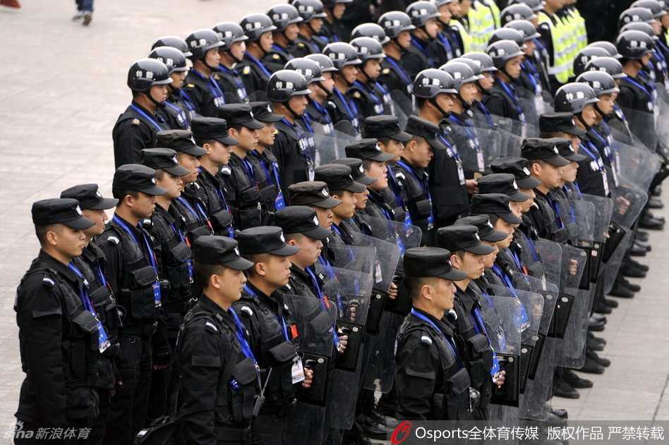 夜色渐浓，场馆外依旧灯火通明。数名特警紧握钢枪，背靠背呈战术队形站立，坚毅的背影后是散场的人流，他们是狂躁情绪外最冷静的守护神。