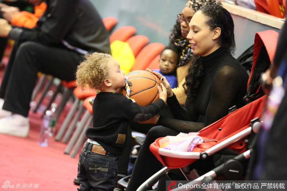 比斯利的大儿子紧紧将篮球抱在怀里，眼神中透露出对这颗圆圆皮球的无限好奇，仿佛在说这是爸爸的魔法道具