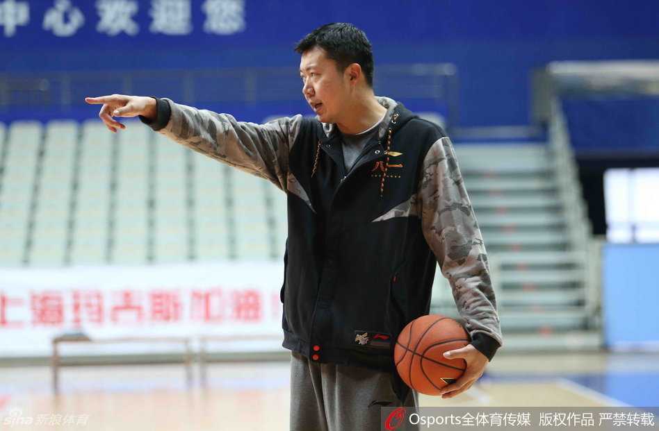 王治郅在训练中神情专注，微微俯身指导年轻队员，宽厚的肩膀仿佛仍能扛起内线重任