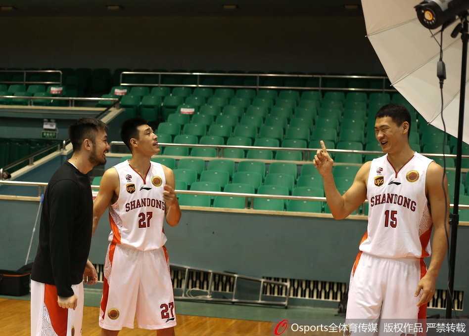 几名山东男篮的队员围在一起，对着镜头做出夸张的表情，丁彦雨航站在中间被队友们簇拥着，大家的手搭在一起，展现着团队的凝聚力。