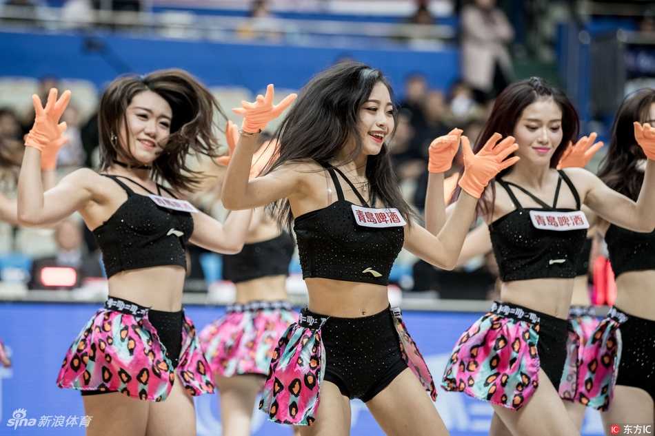 暂停时段，宝贝们近距离为观众表演。画面中这位姑娘有着精致的妆容和甜美的酒窝，她弯腰与场边小球迷互动，温柔的笑容极具亲和力，让人感受到篮球不仅是竞技，更是一种传递快乐的媒介。