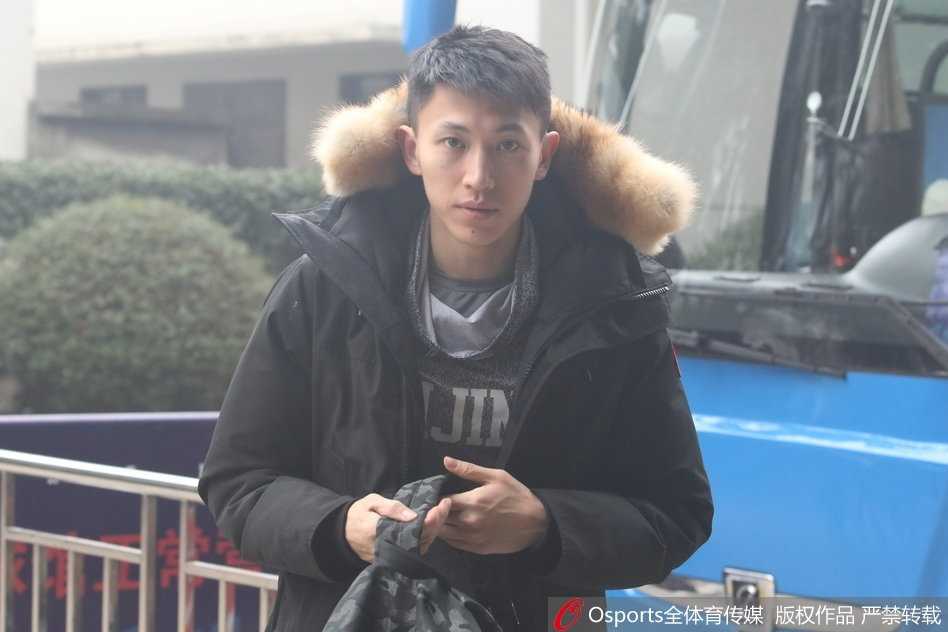 北京首钢男篮全体队员在教练组指挥下，正围绕中圈进行赛前拉伸训练，大家神情专注，气氛严肃而充满斗志