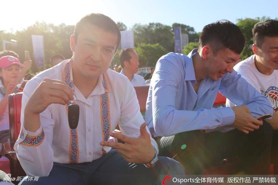 西热力江眼含笑意，高高扬起手中的林肯车钥匙，在镜头前尽情展示着这份沉甸甸的冠军犒赏，身旁的队友们也被这欢乐的气氛感染。