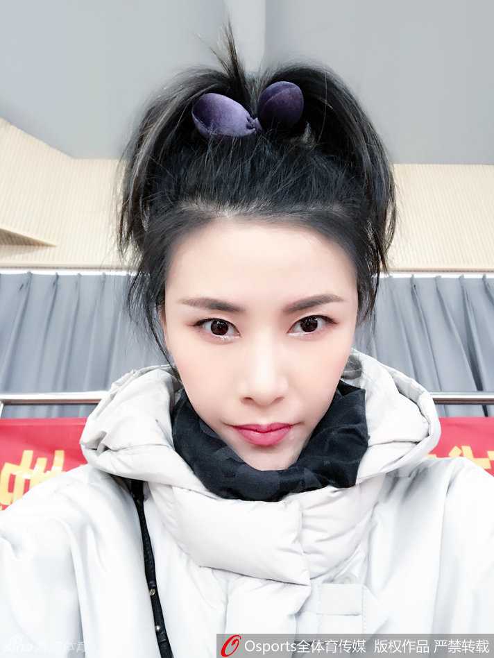 许诺身穿黑色运动装，在训练馆中专注地进行拉伸，身体的柔韧性展露无遗，仿佛在诉说着一个运动员背后日复一日的坚持与自律。