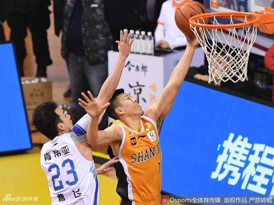 暂停时刻，江苏肯帝亚的替补席气氛凝重，主教练贝西诺维奇手持战术板躬身部署，球员们聚精会神聆听，大战的紧张感在这一刻凝固。