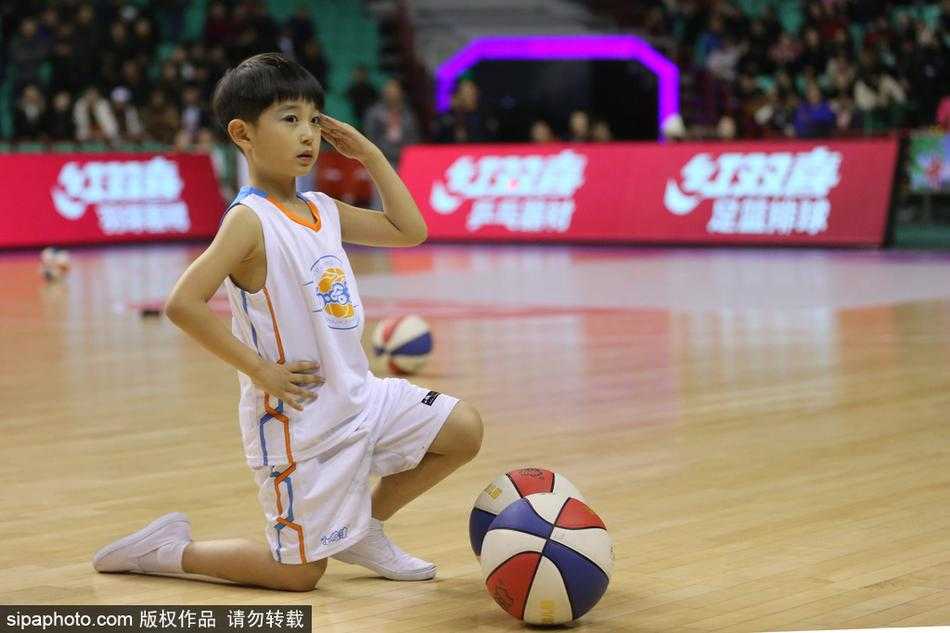 队形变换瞬间，萌娃们围成一个圈，中间一个小个子男孩高高抛起篮球，周围所有孩子仰头望球，脸上写满了期待与惊喜，画面充满了童趣和动感。