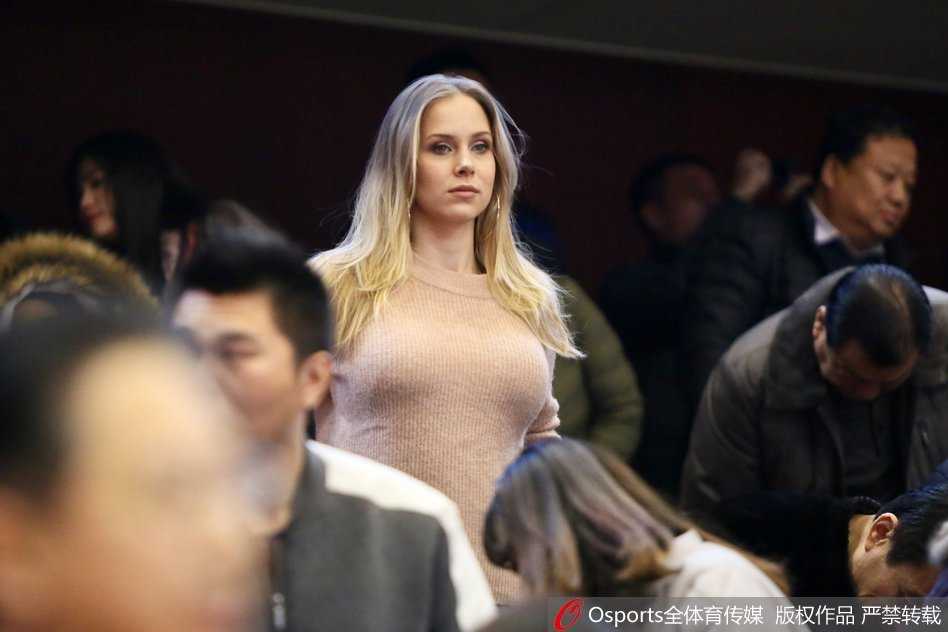 莫泰尤纳斯娇妻现场助阵,山东男篮激战江苏肯帝亚 莫泰尤纳斯的妻子与身边的亲友团成员交流,脸上洋溢着轻松的笑容,显然对丈夫在场上游刃有余的表现感到十分安心和骄傲。