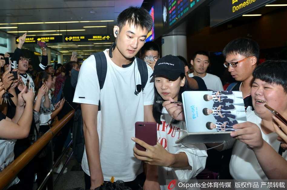 卫猛推着行李车走出机场，作为冠军成员分享着全队圆梦的喜悦与荣光