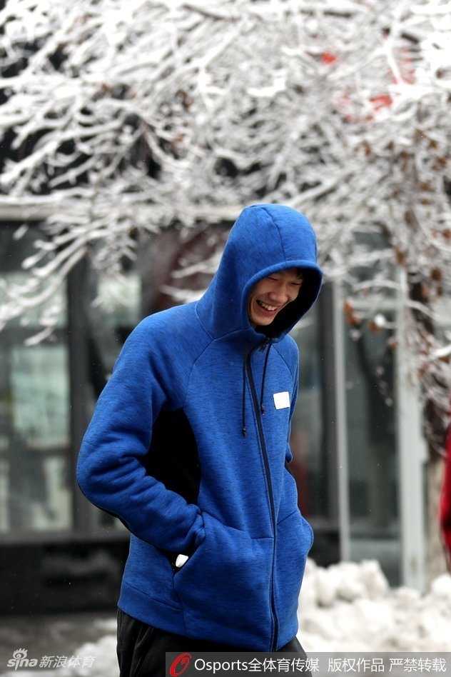 广厦球员在乌鲁木齐大雪中集体看向镜头，天空飘落的雪花为这幅赛前放松的画面增添了浪漫色彩。